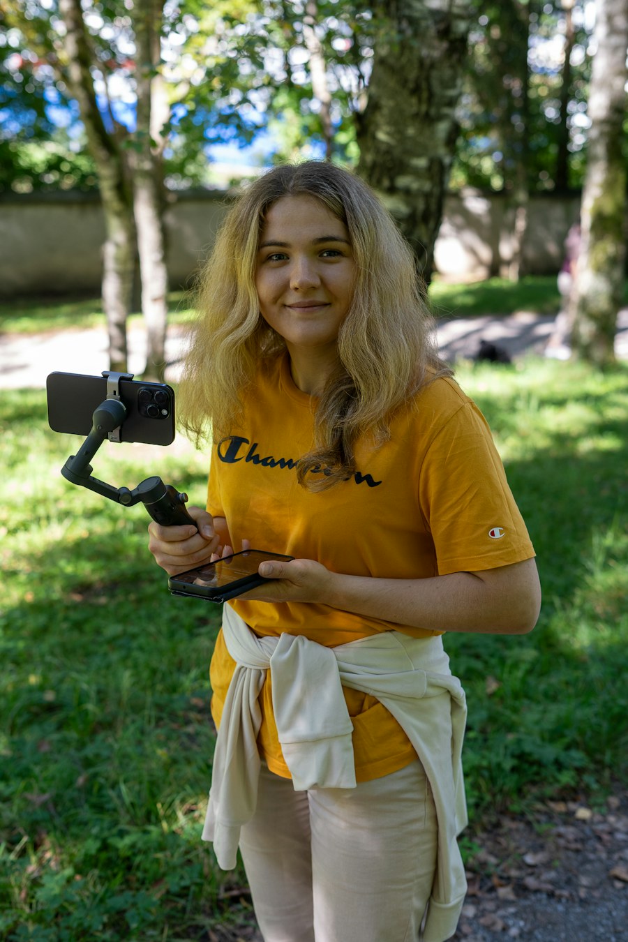 A woman filming with a phone on a gimbal
